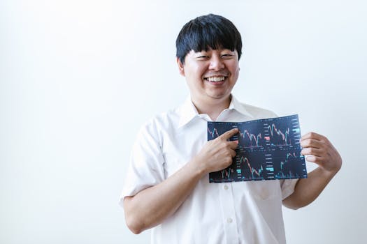 Smiling man presenting cryptocurrency investment chart indoors.